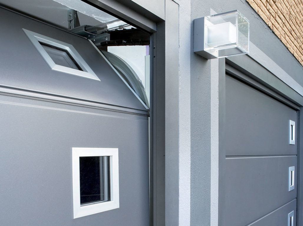 Oxley Solid Sectional Garage Door Finished In Smooth Grey Aluminium With Stainless Steel square windows