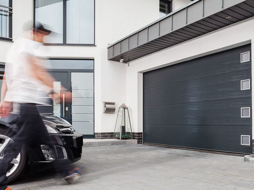 Oxley Solid Sectional Garage Door Woodgrain Textured Finished In Anthracite Grey With Stainless Steel Square Windows